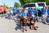 Willow visiting with the kids at school after putting on a demonstration.