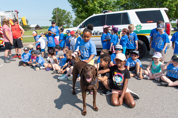 Willow visiting with the kids at school after putting on a demonstration.